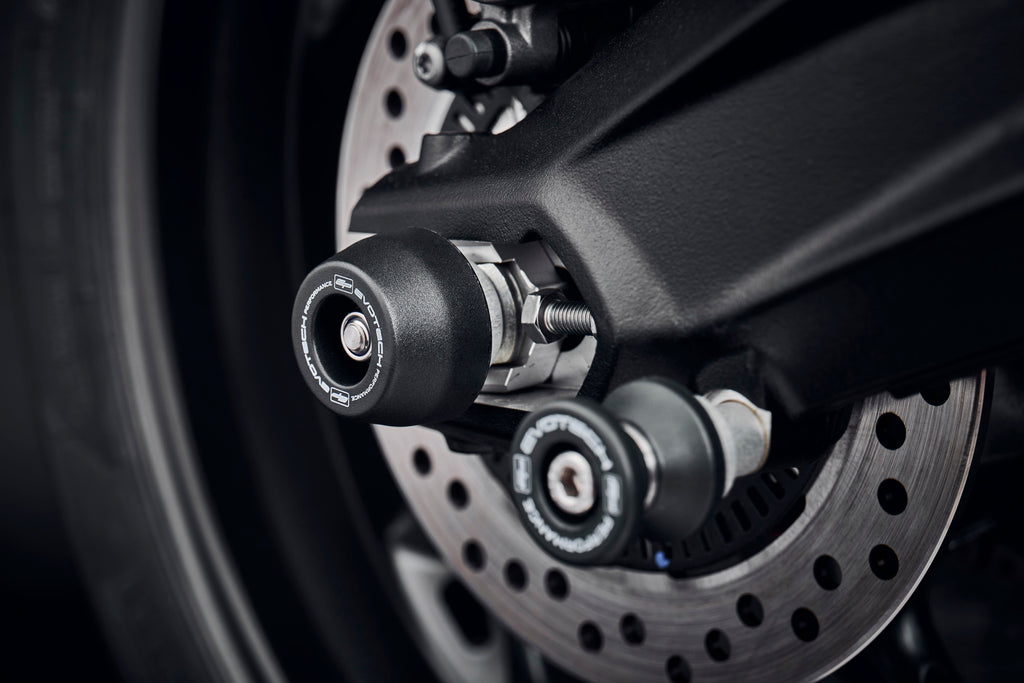 The rear wheel and swingarm of the Triumph Street Triple 765 Moto2 Edition with EP Rear Spindle Bobbins installed to offer Evotech Performance’s crash protection to the motorcycle’s rear end. 