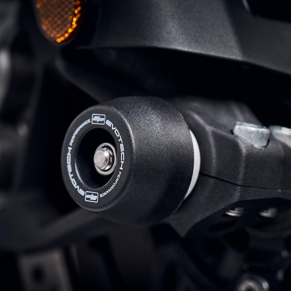 The nylon crash protection bung from EP Front Spindle Bobbins extends from the front wheel of the Triumph Tiger 1200 GT, guarding the lower front forks and brake calipers.