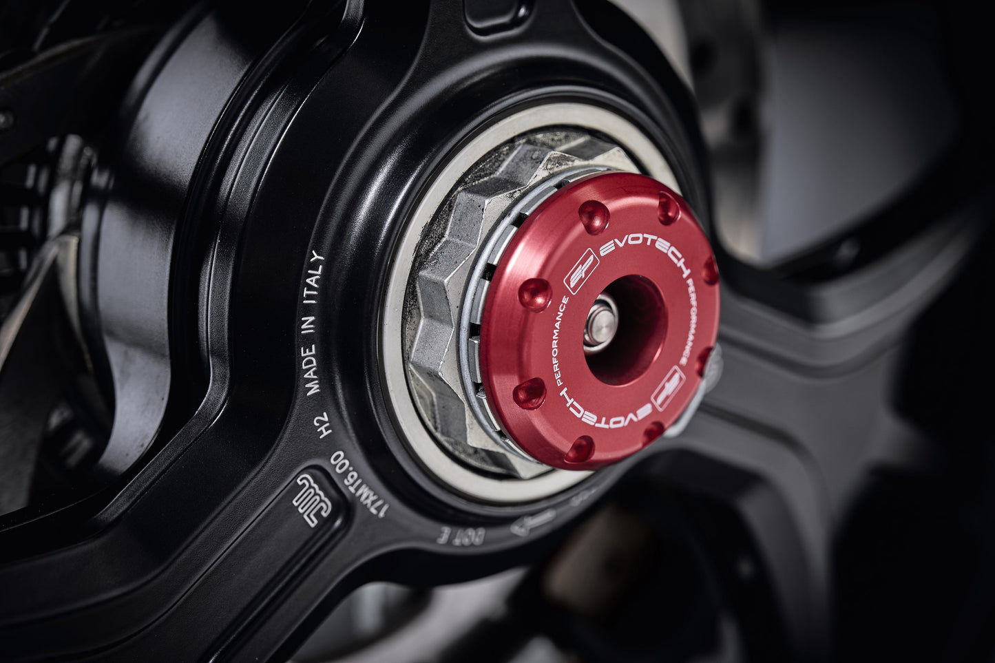 The striking anodised red hub stop from the EP Spindle Bobbins Crash Protection Kit fitted to the offside rear wheel of the Ducati Multistrada 1260.