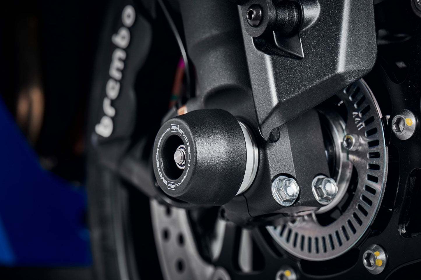 The EP Spindle Bobbins extends from the rear swingarm of the Suzuki GSX-S1000GT to shield the swingarm of the rear wheel, sitting near the EP Paddock Stand Bobbins. 