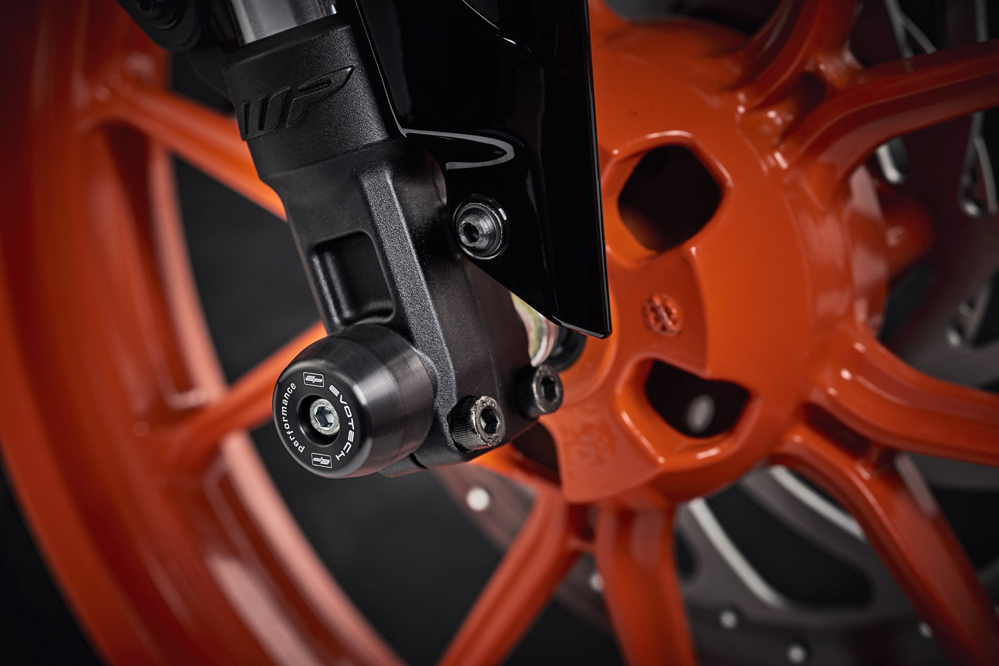 The lower front fork of the KTM RC 200 with EP Front Spindle Bobbins securely attached, offering crash protection to the motorcycleâ€™s front wheel.