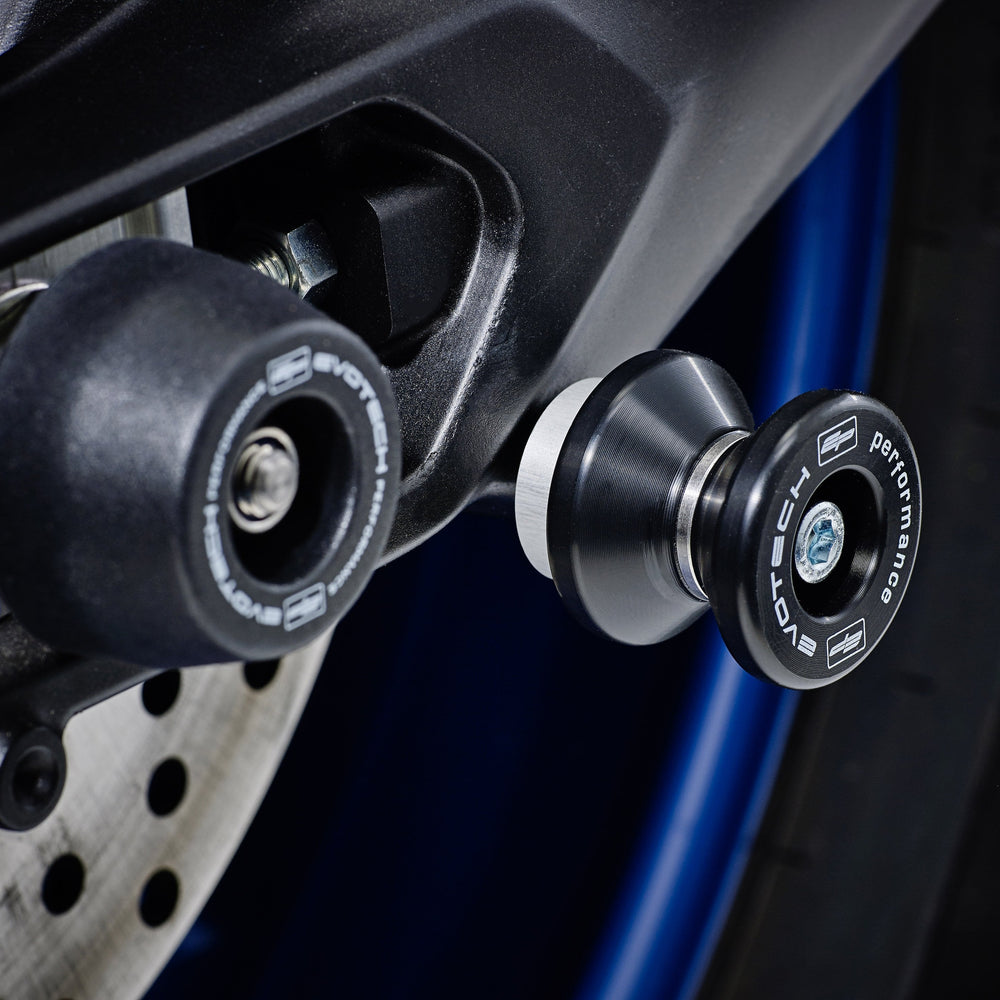 The swingarm of the Yamaha Tracer 700 with EP Paddock Stand Bobbins installed near EP Rear Spindle Bobbins Crash Protection. 